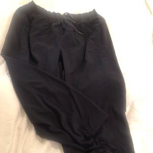 Ankle length drawstring pants. Parachute material